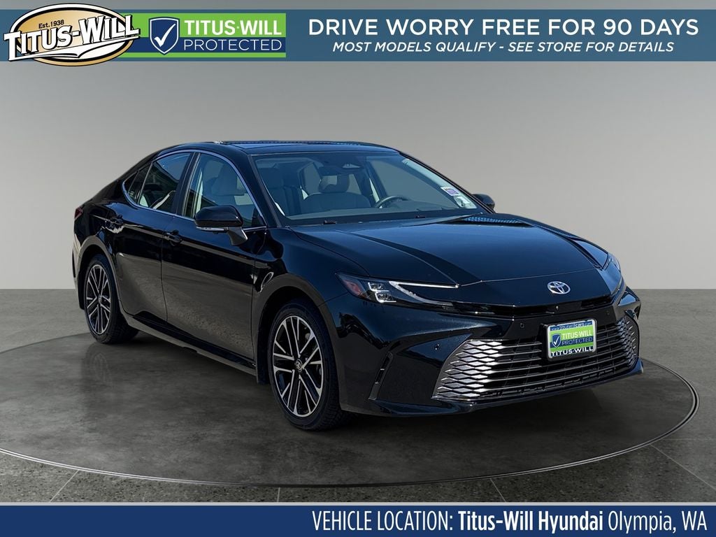 2025 Toyota Camry XLE Hybrid AWD in Black — front three-quarter view